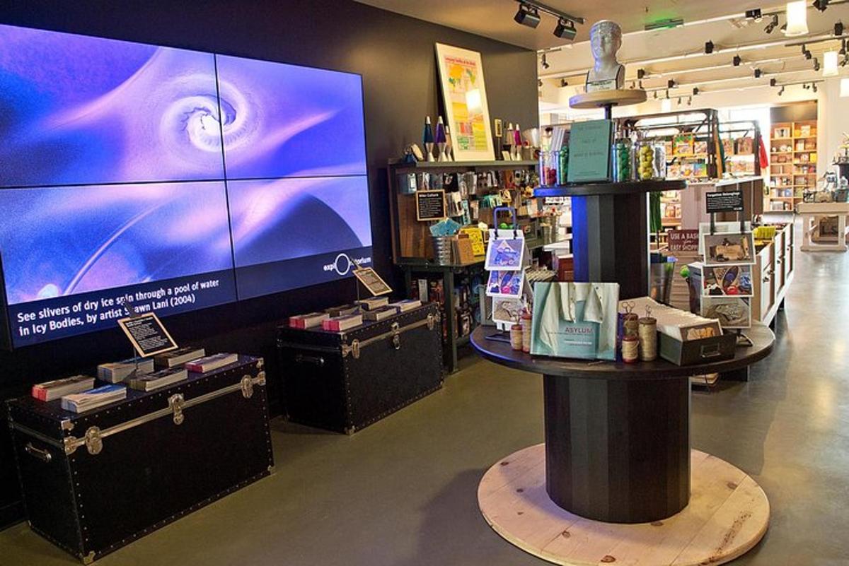 a store with a large tv and a display of products