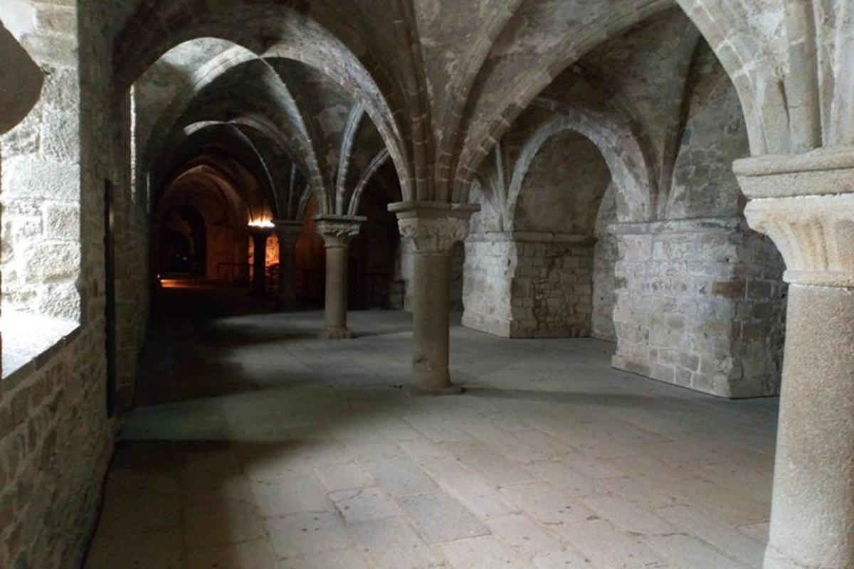 an empty hallway in a castle with arches