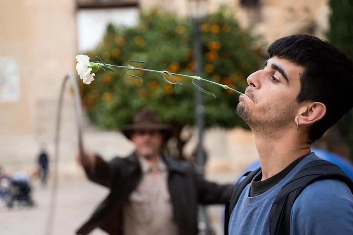 a man eating a flower in front of a woman