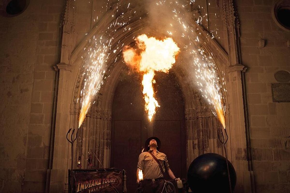a man standing in front of a building with fire