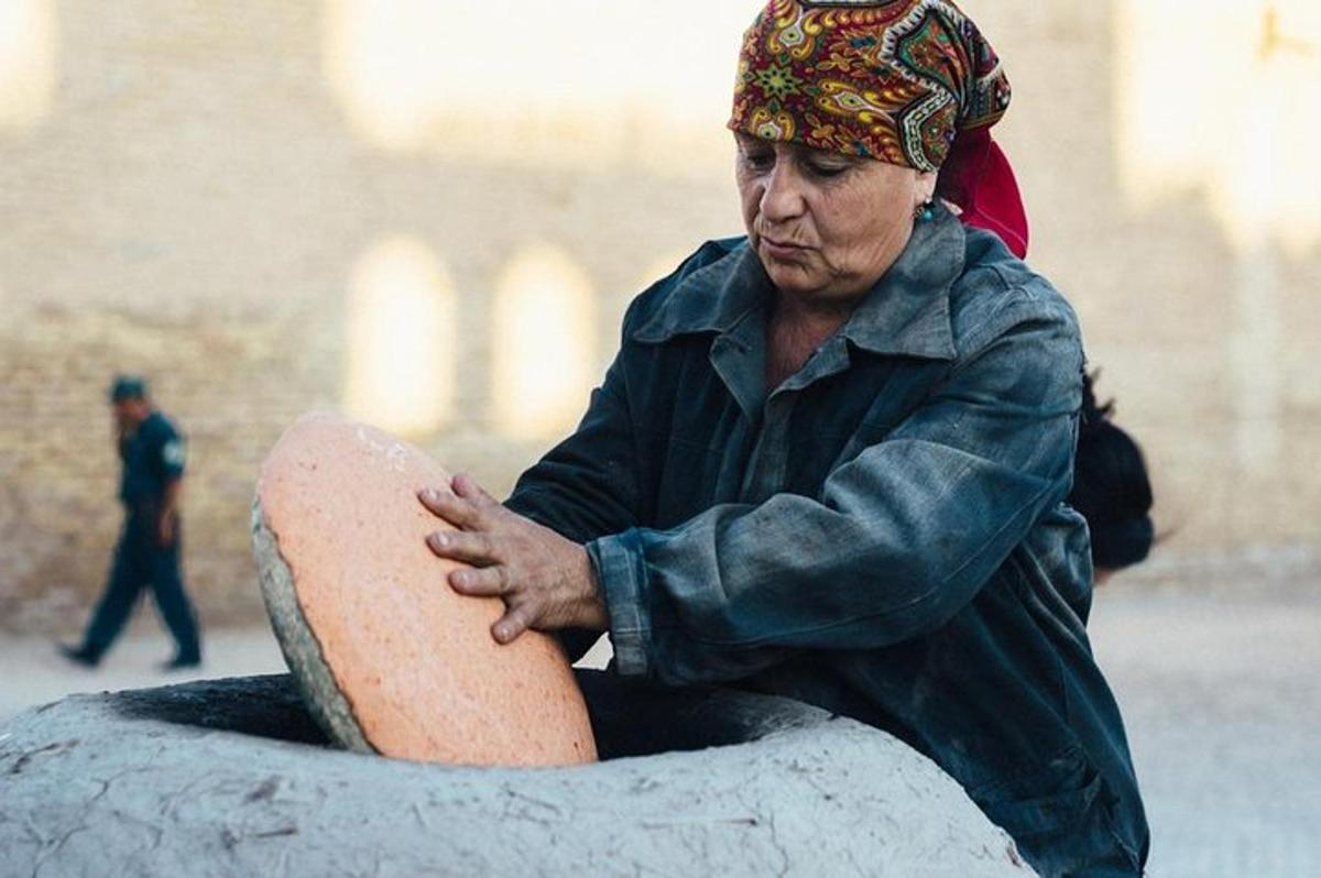 a woman sitting on top of a statue