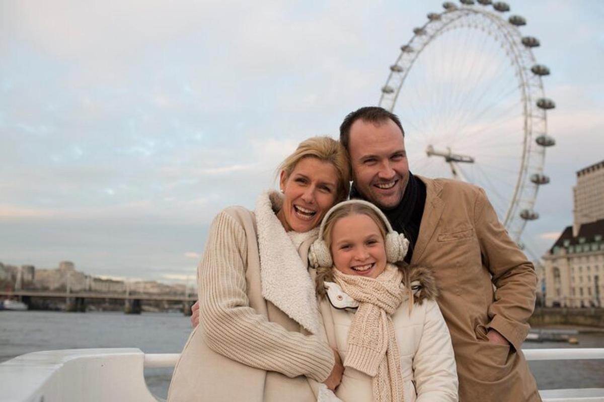 a man and woman posing for a picture in front of the london eye