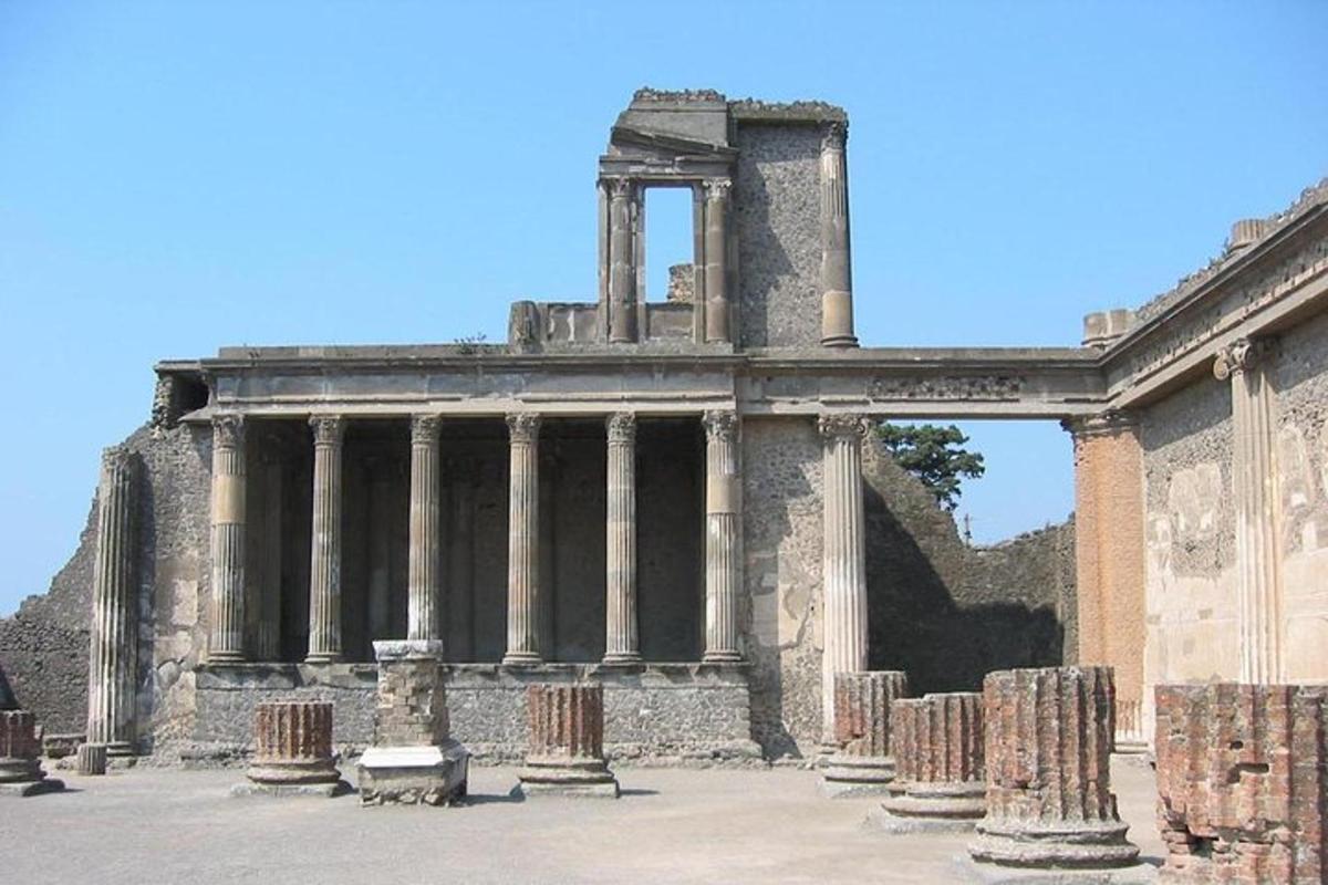 an ancient building with columns in a courtyard