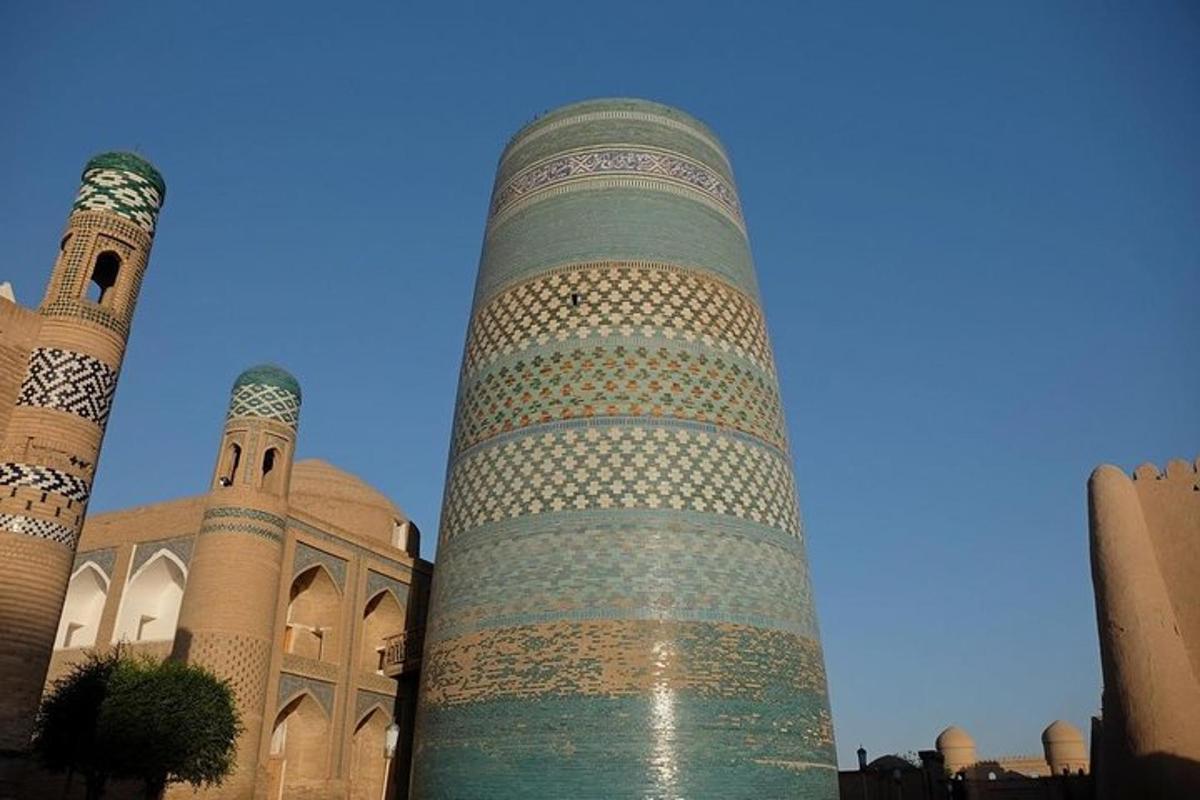 a tall tower in front of a mosque