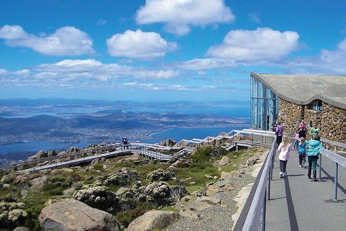 a group of people walking up the side of a mountain