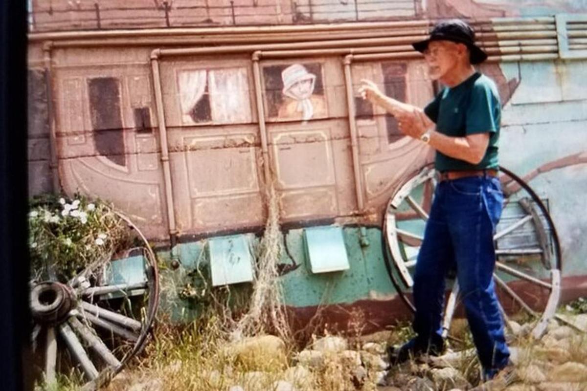 a man standing in front of a train car