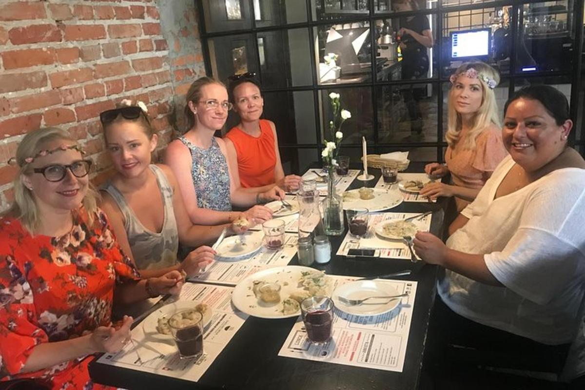 a group of women sitting at a table eating