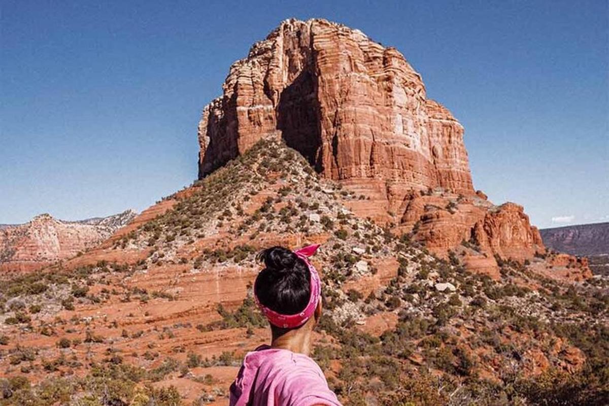 a woman standing on top of a mountain