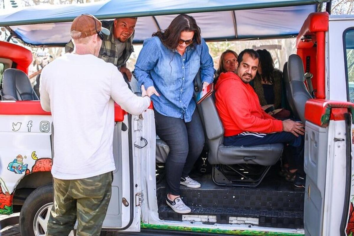 a group of people sitting in the back of a van