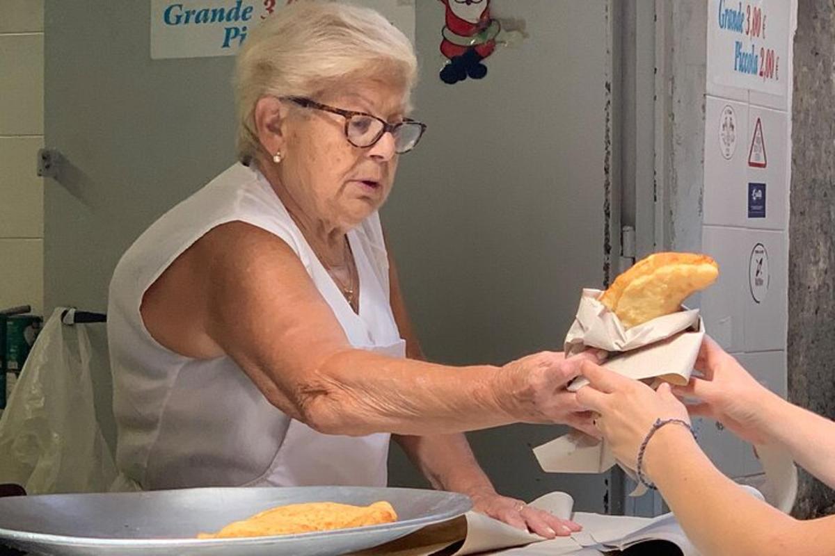 an older woman is holding a plate of food
