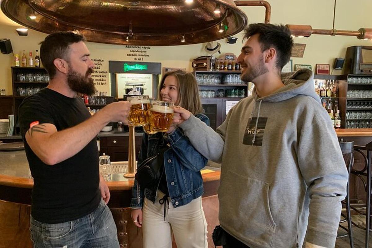 two men and a woman drinking beer at a bar