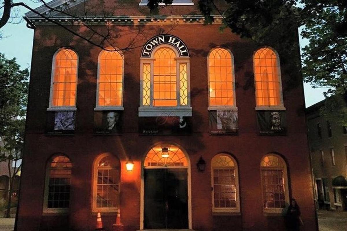 a brick building with orange lights in the windows