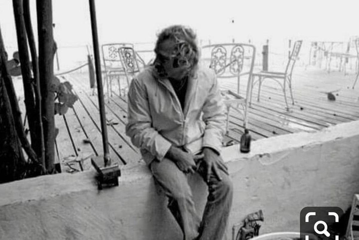 a man sitting on a wall on a patio