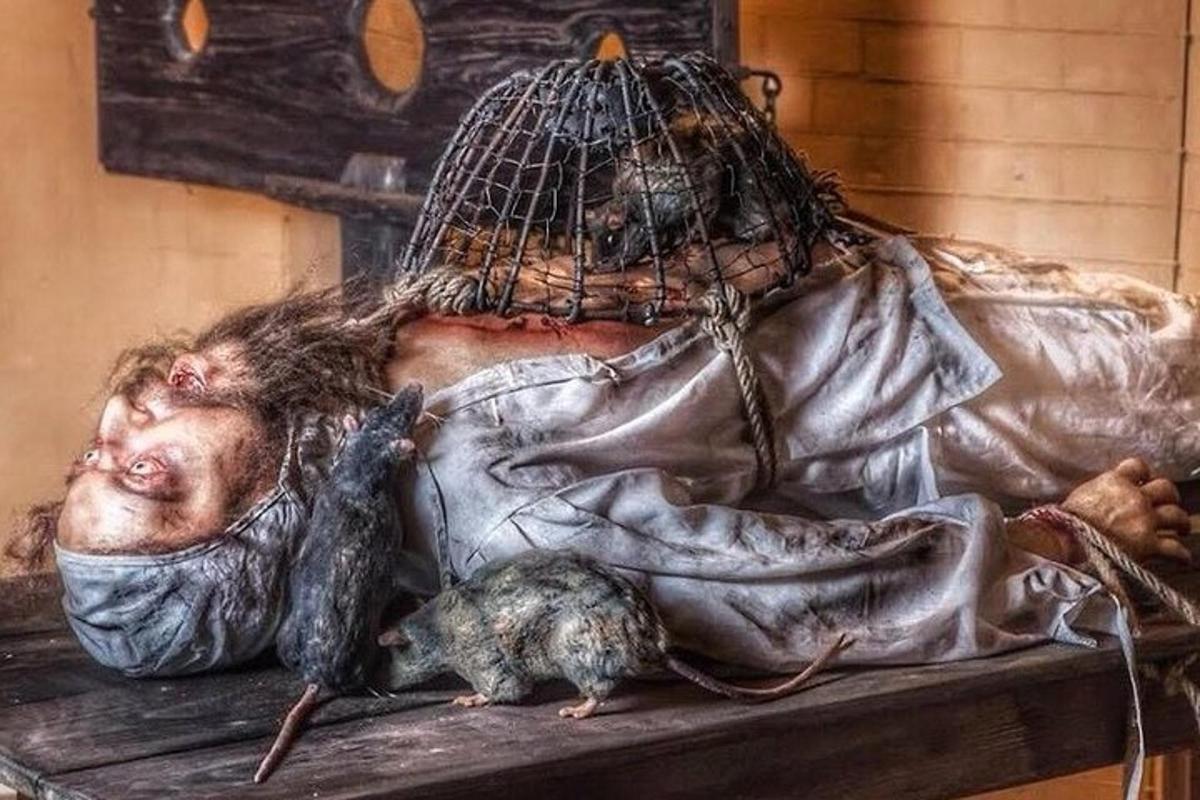 a painting of a man and rats on a table