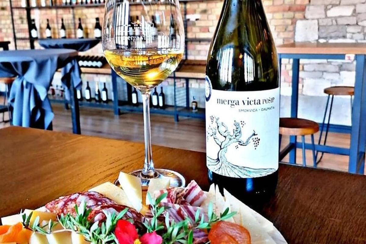 una bottiglia di vino bianco accanto a un bicchiere di vino