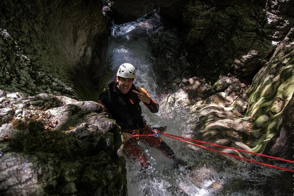 a man standing in a river in a waterfall