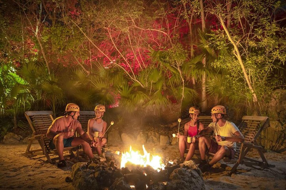 a group of people sitting around a camp fire