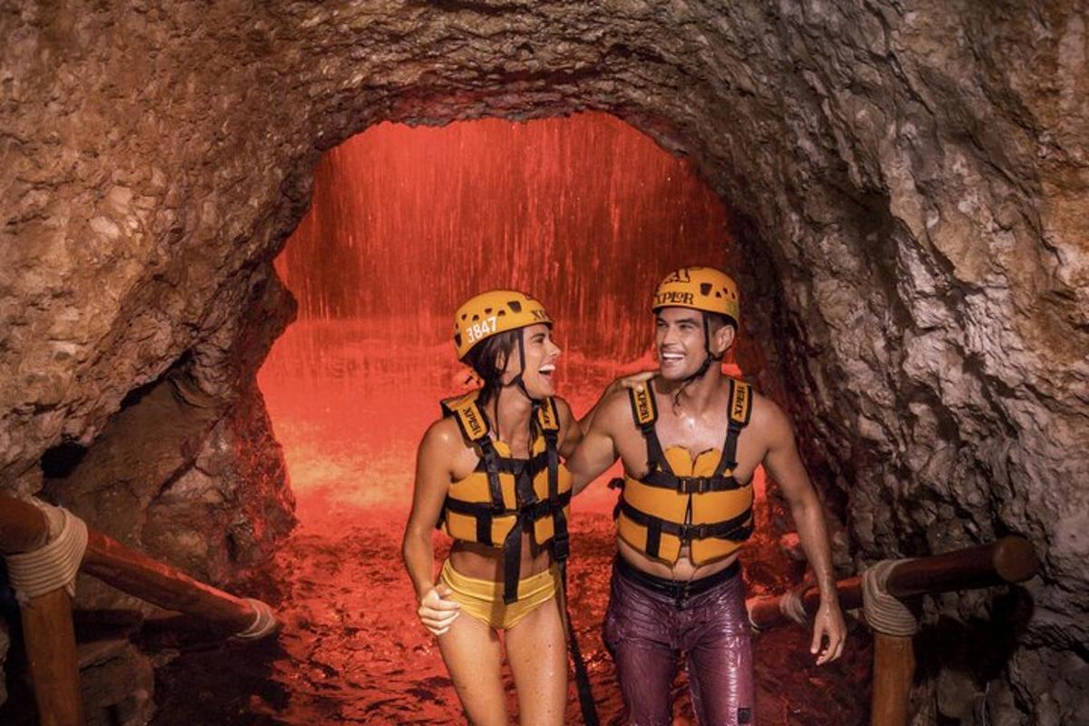 a man and woman wearing life jackets standing in a tunnel