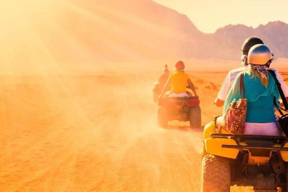a group of people riding on motorcycles in the desert