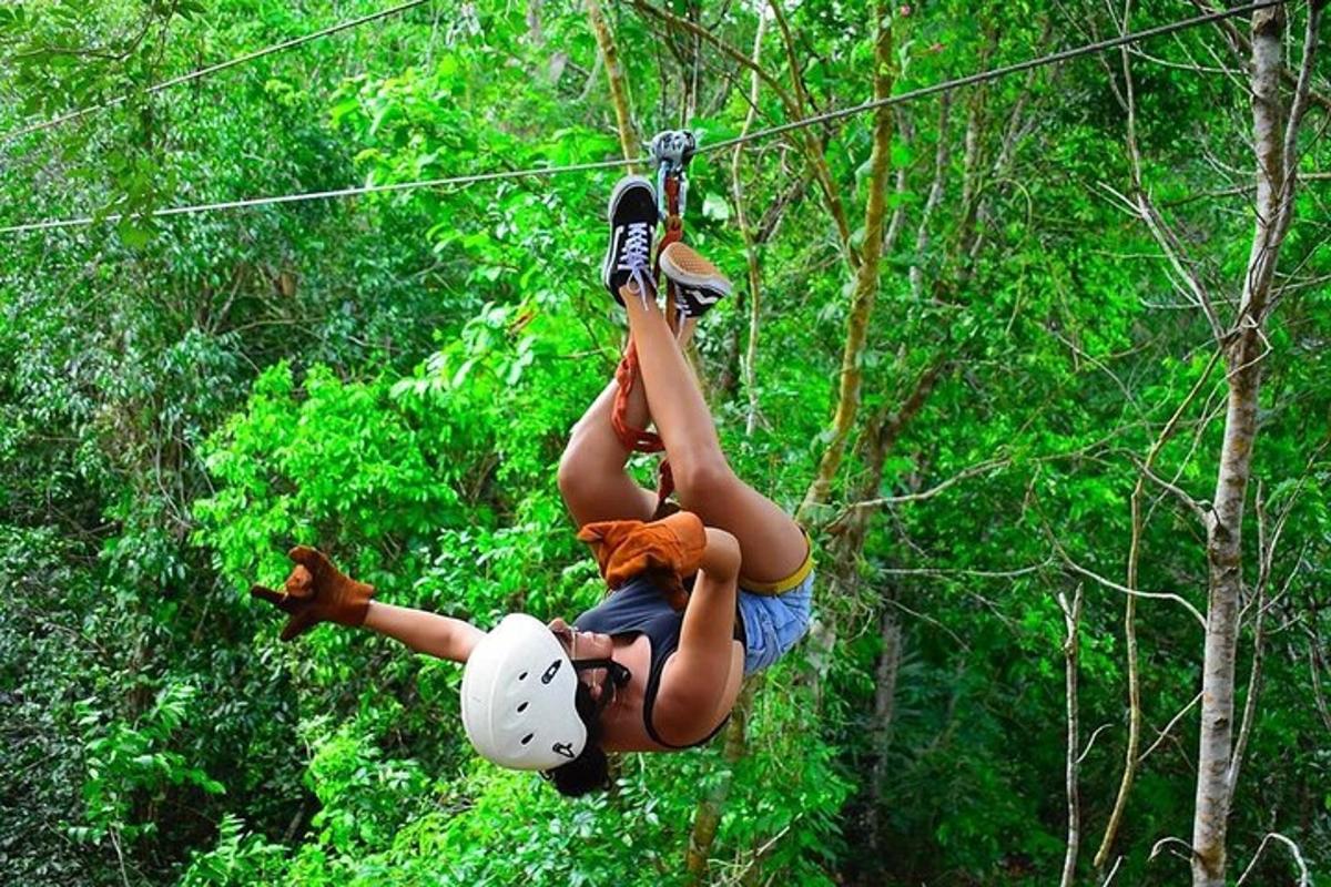 a woman is hanging on a zip line