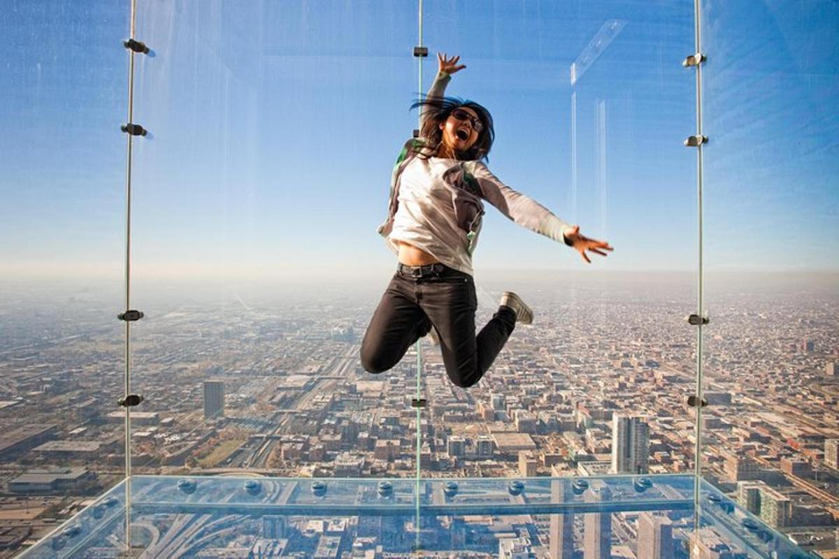 a woman jumping in the air on top of a city