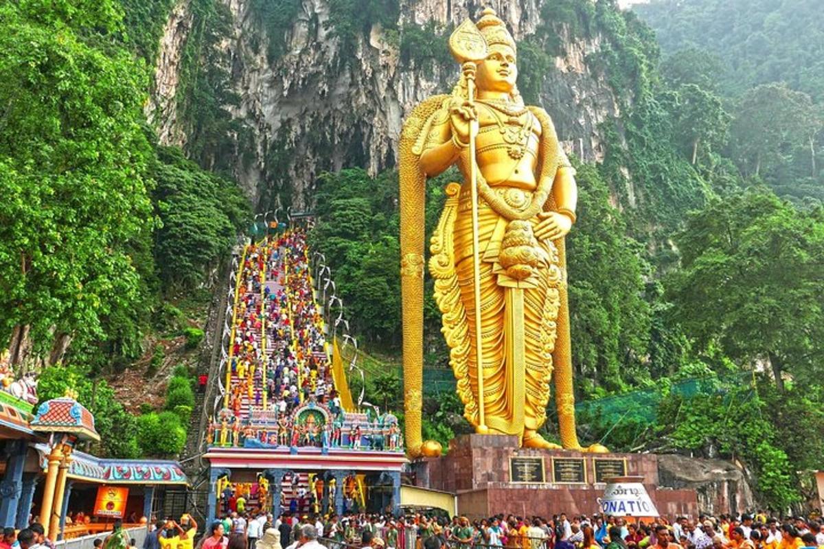 a large golden statue in front of a mountain
