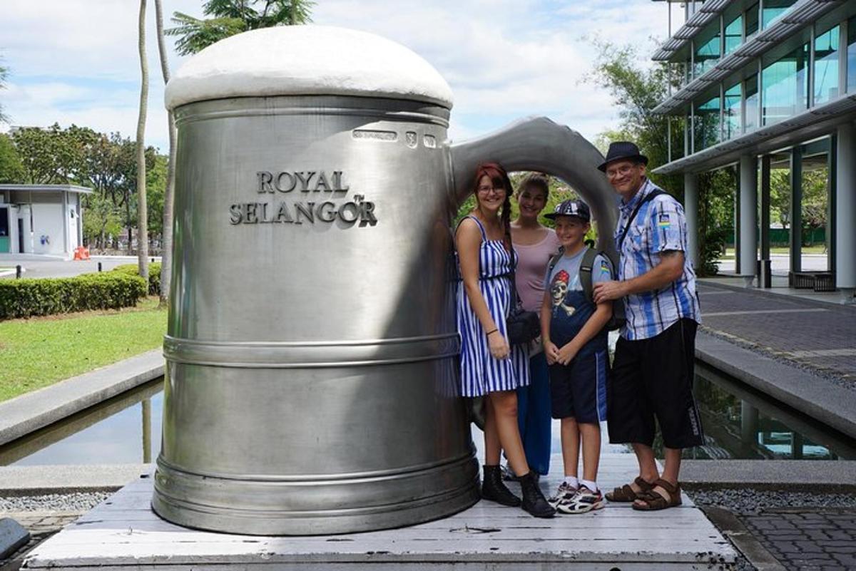 a group of people standing next to a metal cylinder