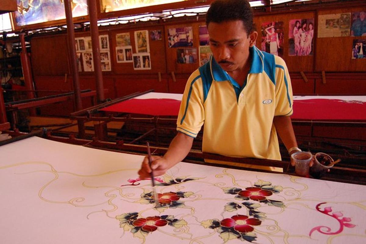 a man cutting out flowers on a table