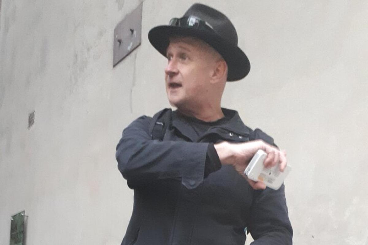 a man wearing a hat holding a wii controller