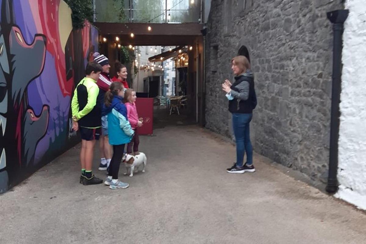 a group of people standing next to a wall