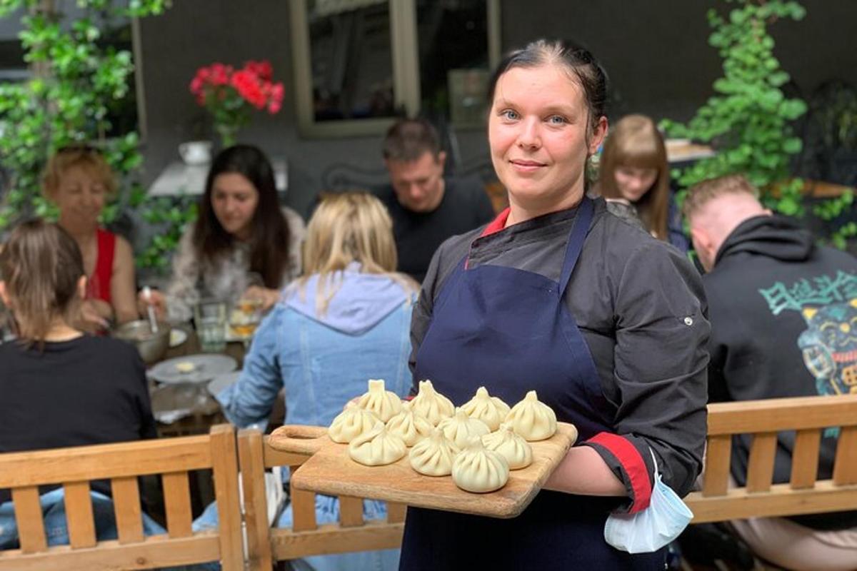 nainen, jolla on tarjotin kuppikakkuja