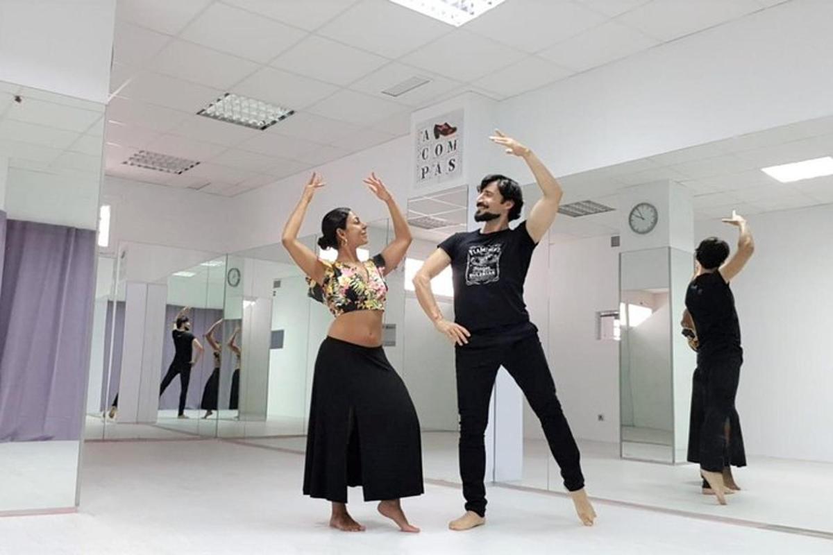 a man and a woman dancing in a dance studio