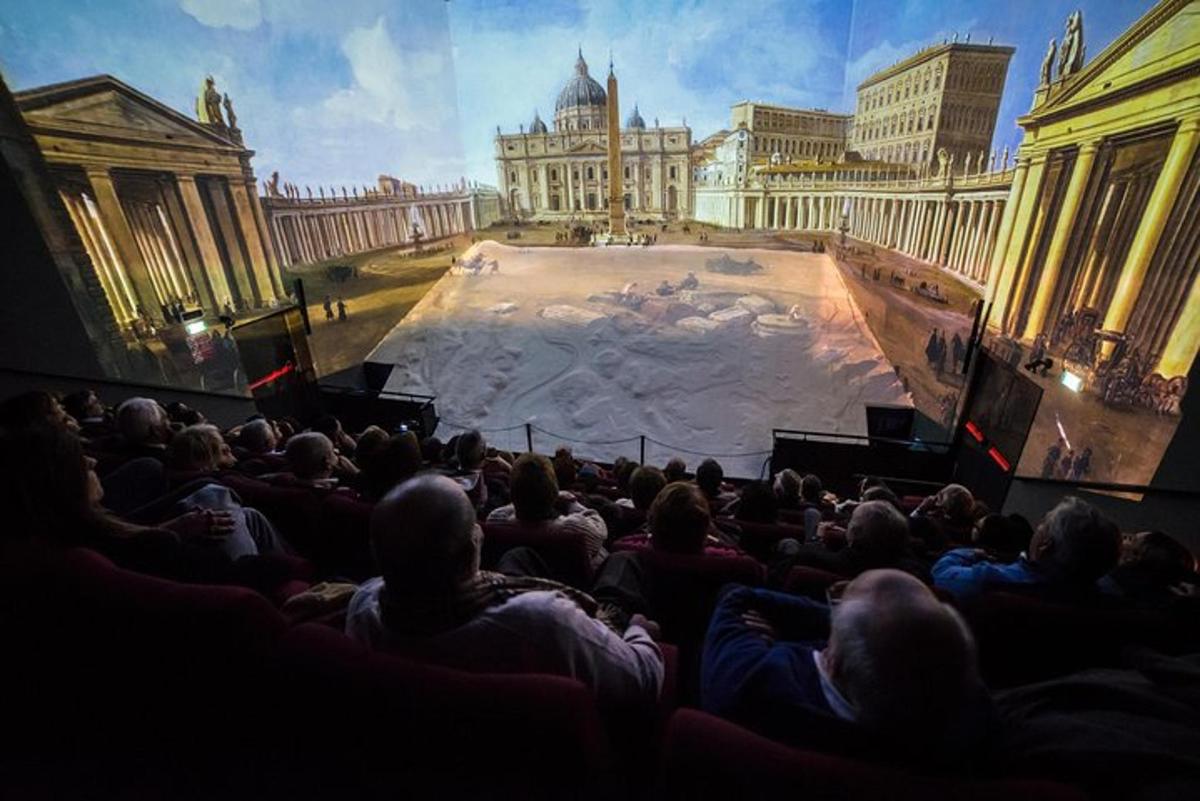 a crowd of people sitting in a theatre watching a show