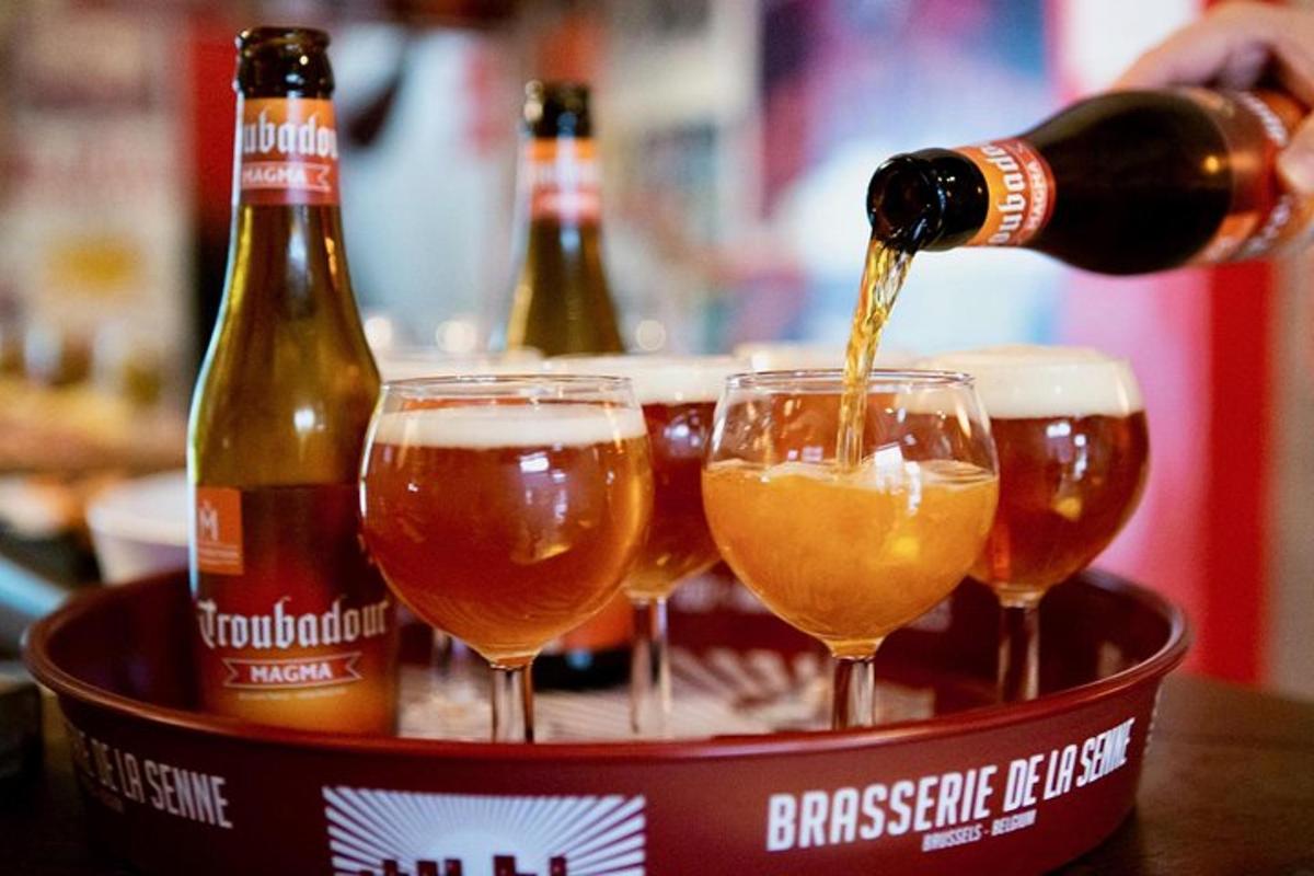 a bucket filled with glasses of beer and bottles