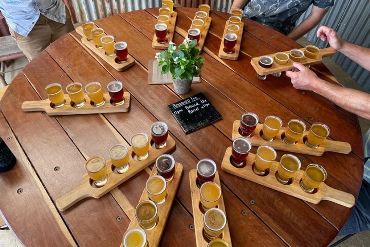 a wooden table with a bunch of glasses of beer