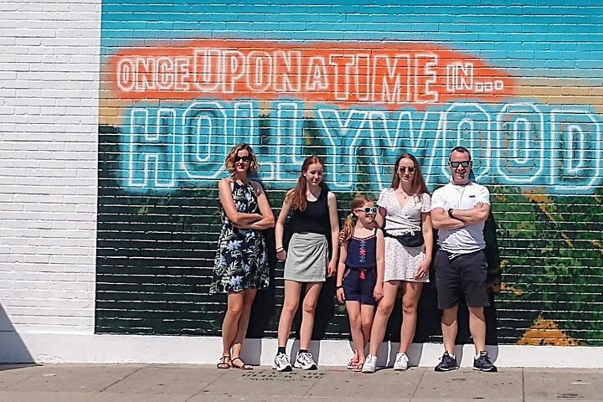 a group of people standing in front of a wall