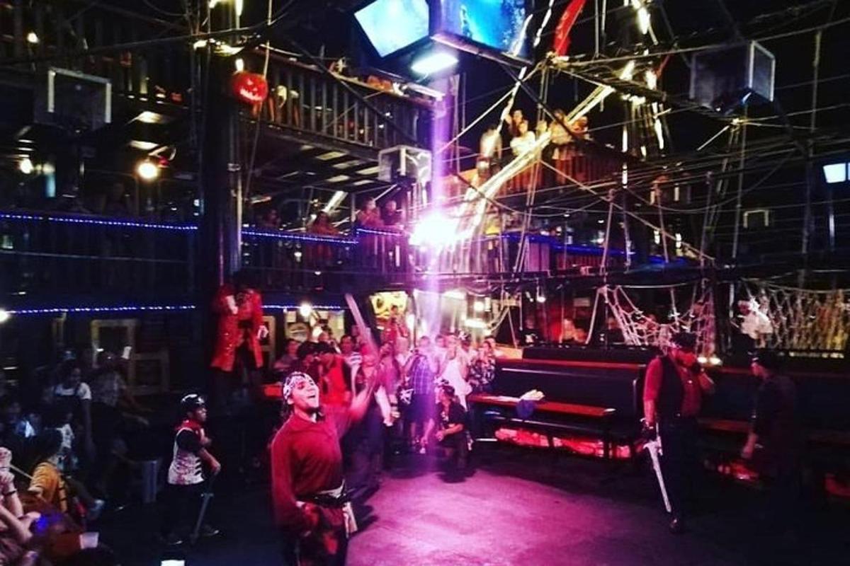 a group of people standing in a room with a stage