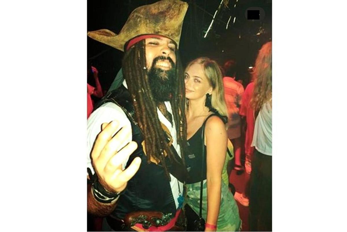 a man and a woman posing for a picture at a party
