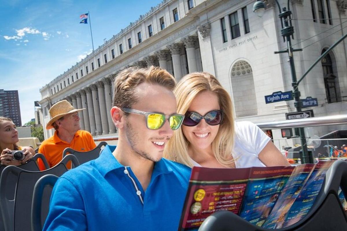 a man and a woman reading a map on a bus