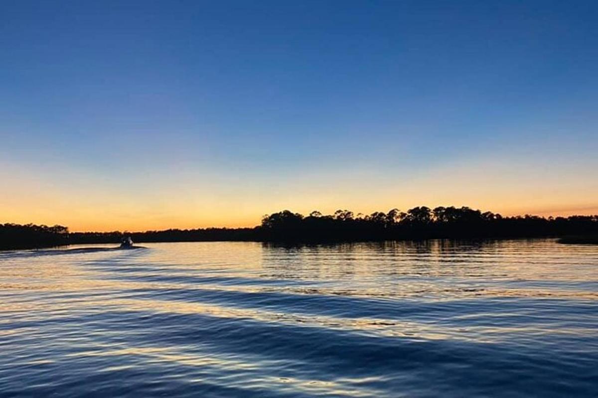 a boat on a river at sunset