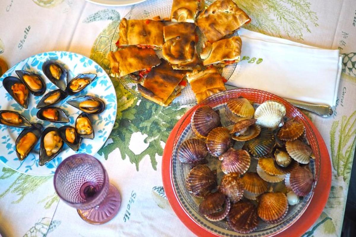 a table with two plates of shells and a plate of food
