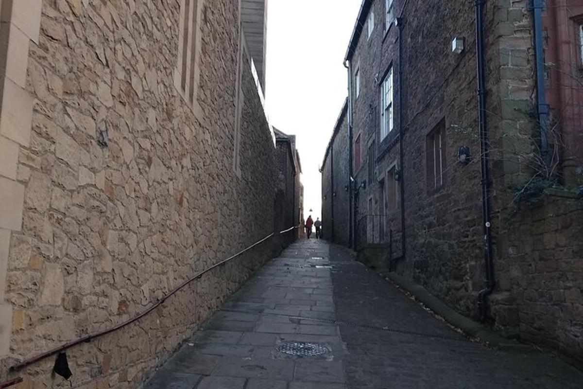 an alley with a person walking down the street