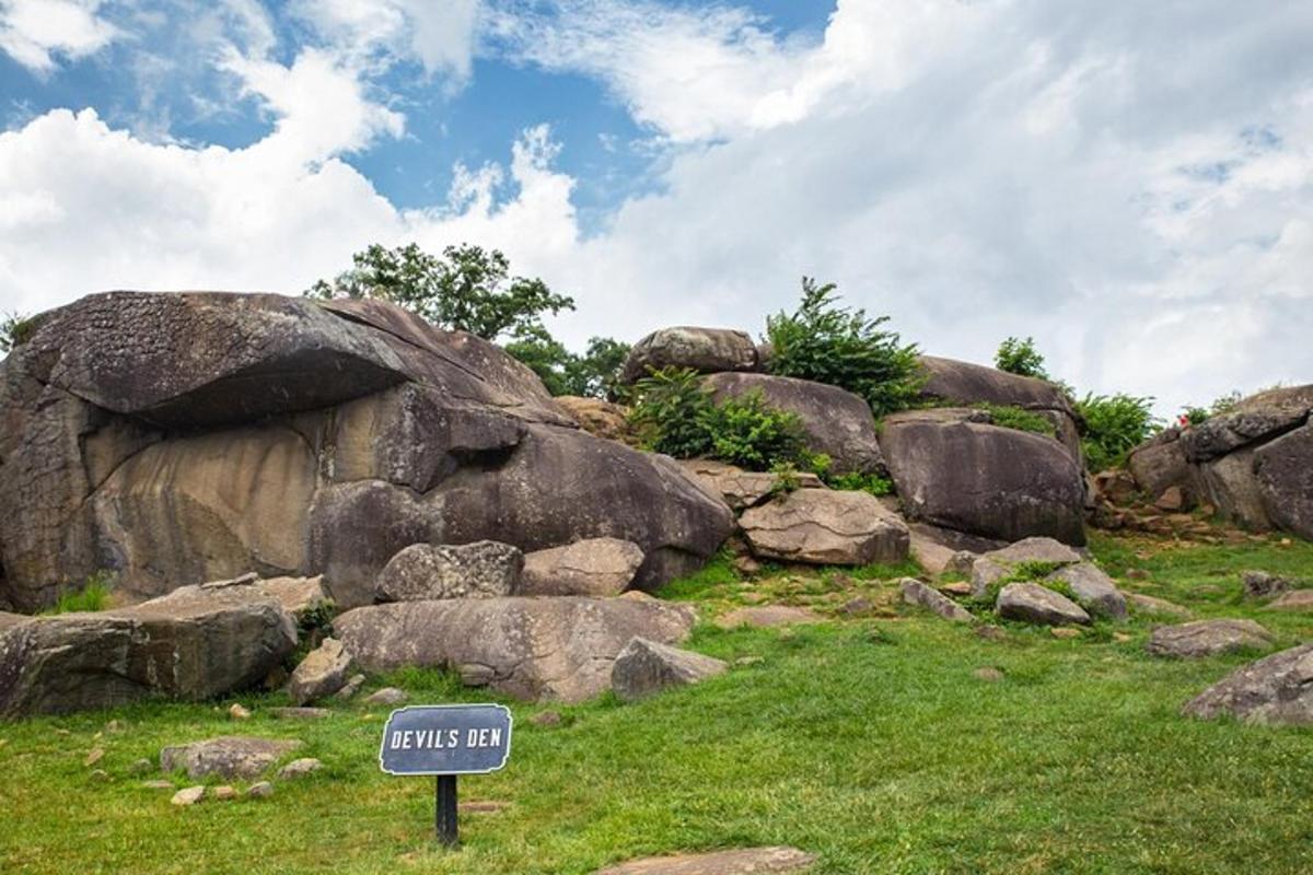 a sign in front of a pile of rocks