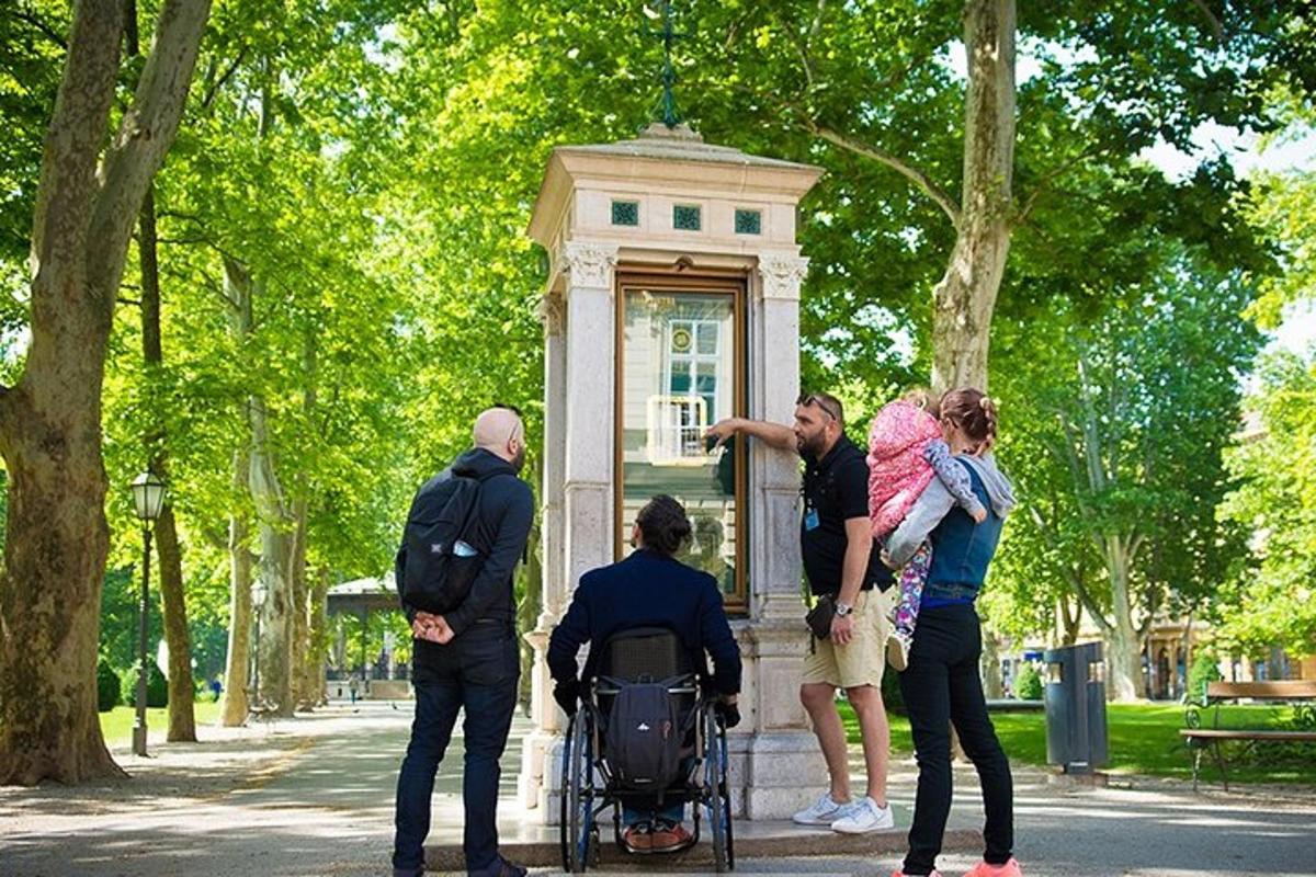 a group of people standing around a statue in a park