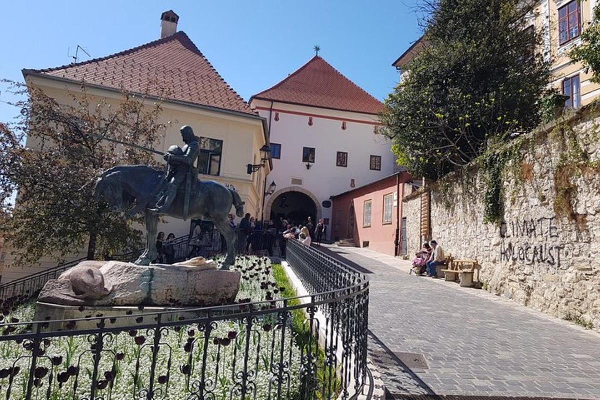 a statue of a man on a horse in front of a building