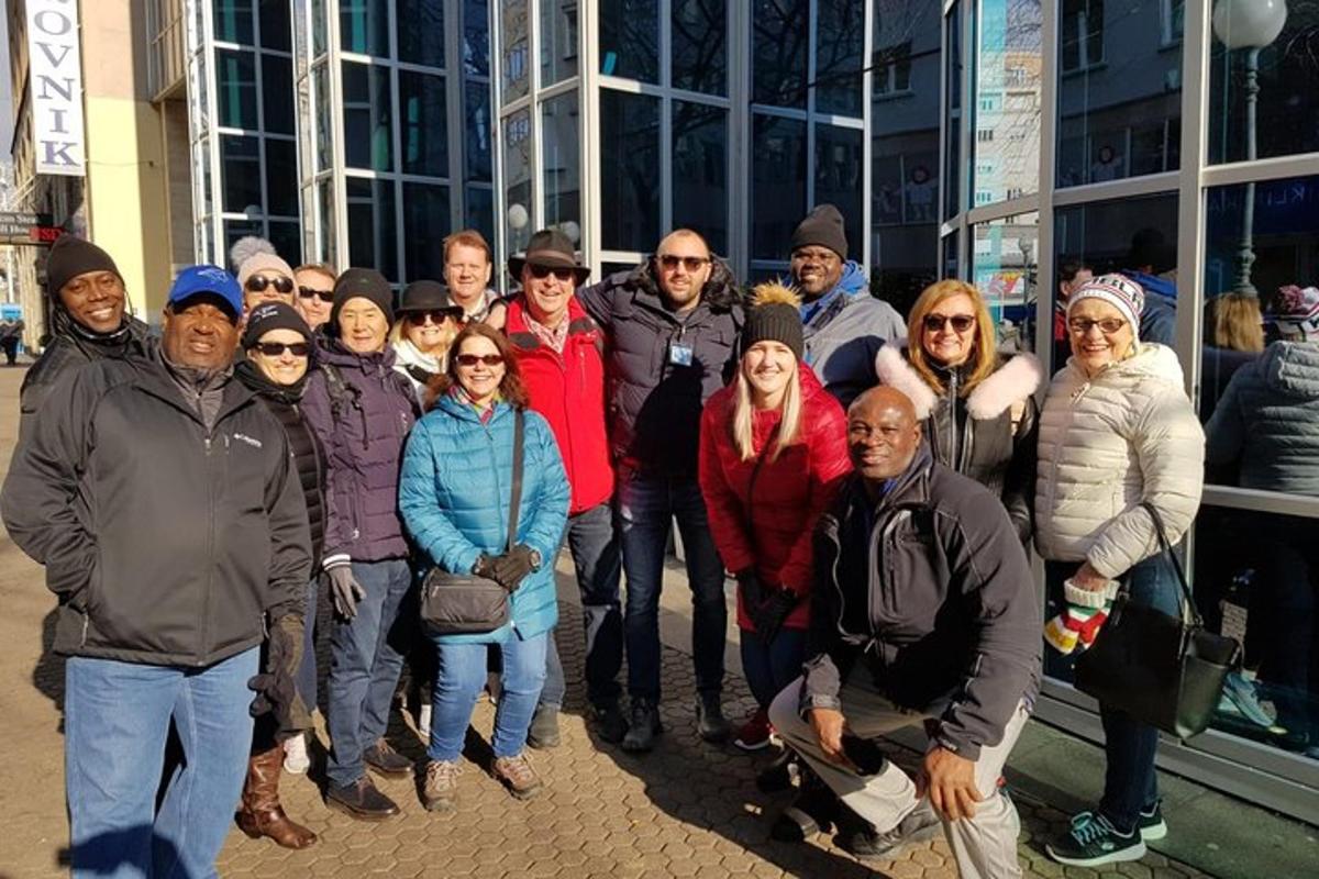 a group of people posing for a picture in front of a building