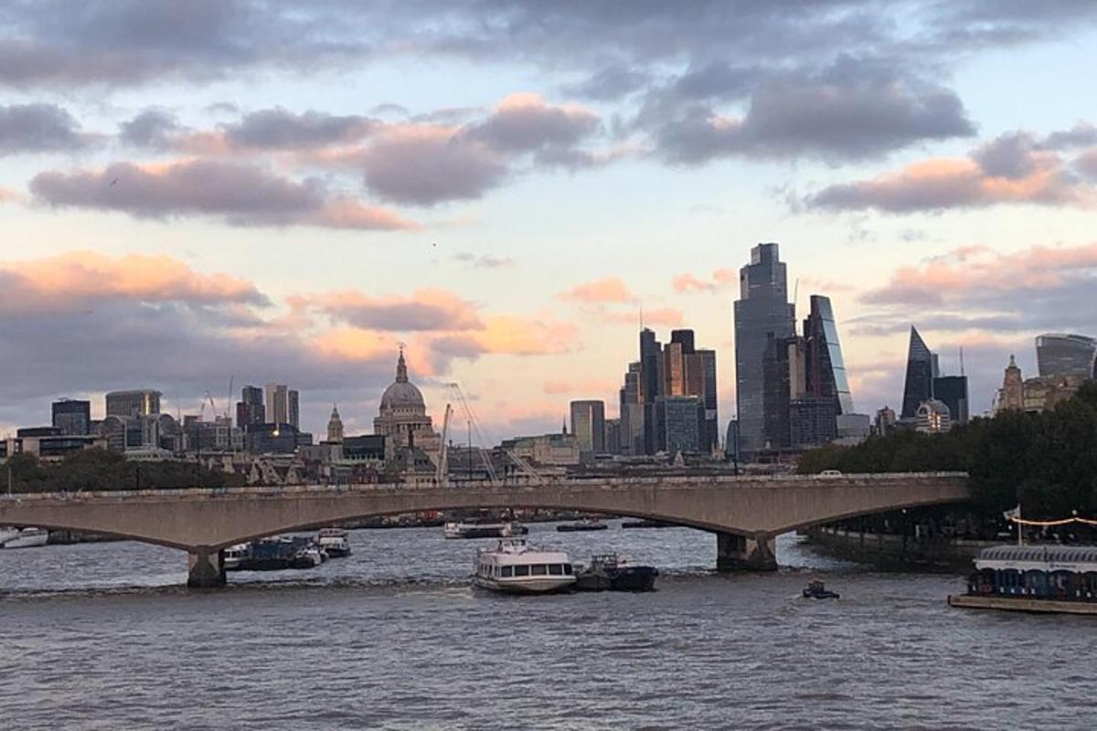 a bridge over a river with a city in the background