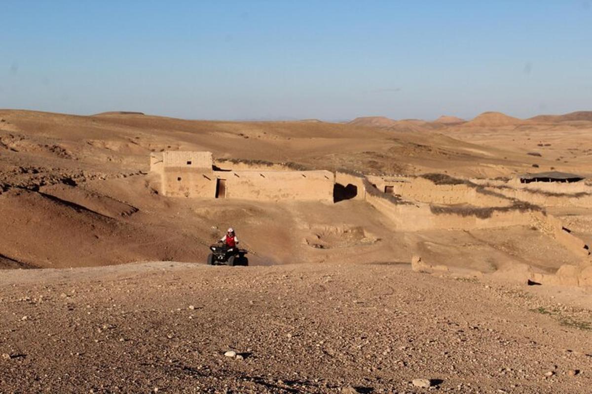 a person riding a motorcycle in the desert