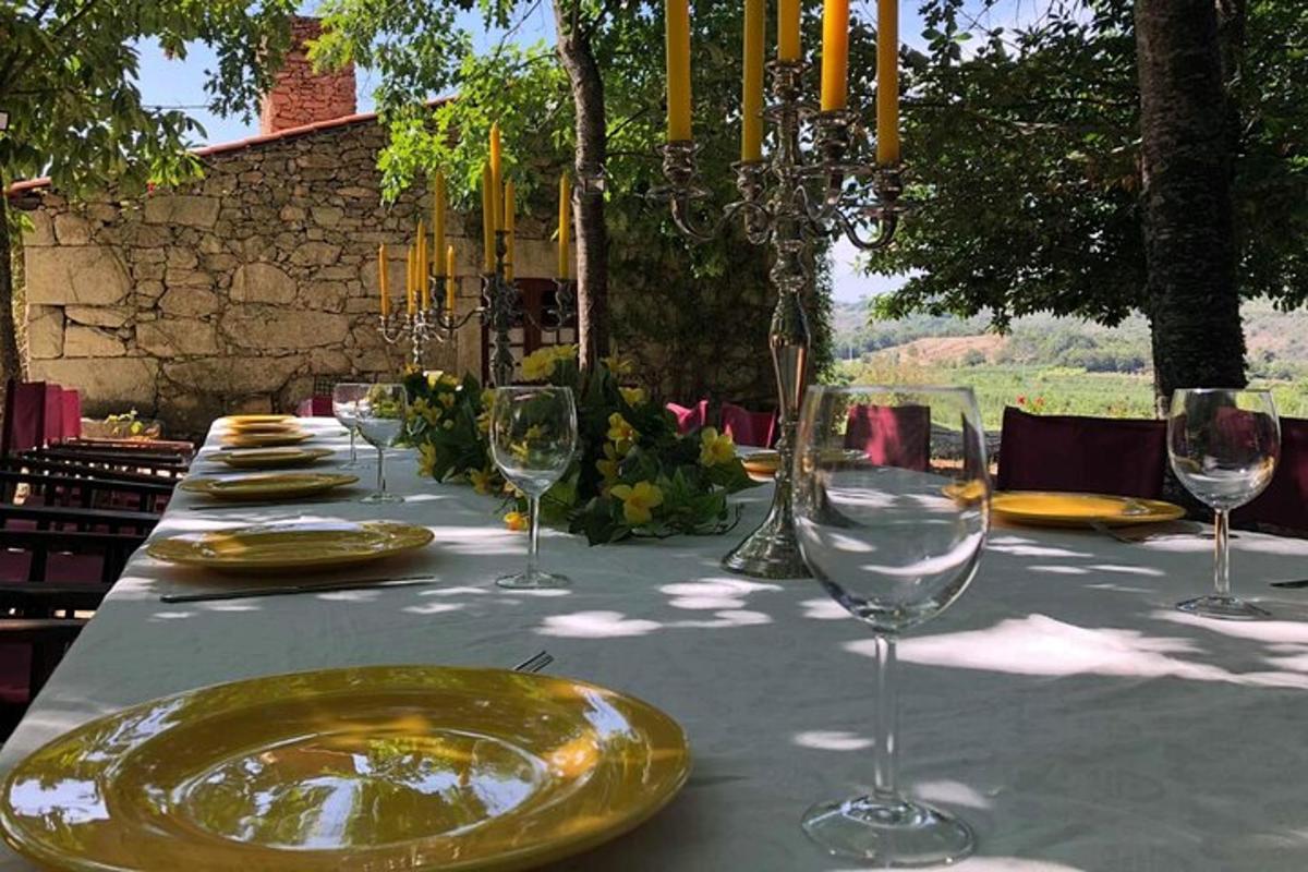 a table with a yellow plate and wine glasses