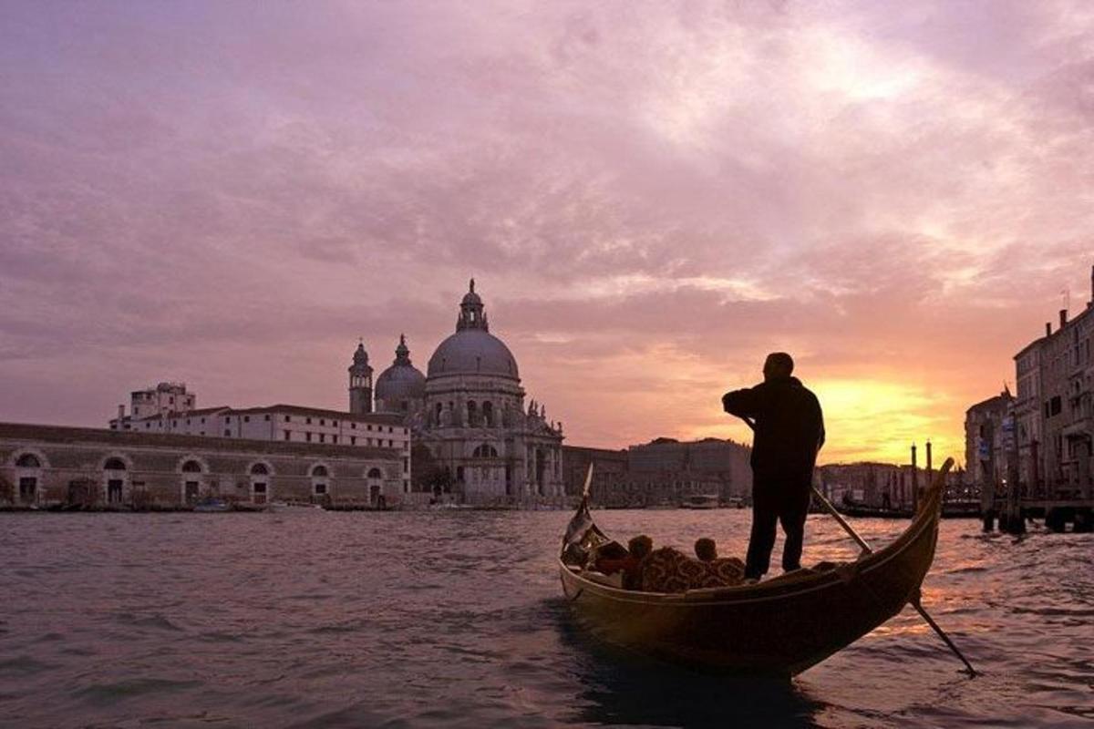 a man is standing in a gondola in the water